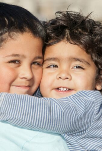 affectionate-little-brothers-hugging-outdoors-2026-01-11-10-13-20-utc